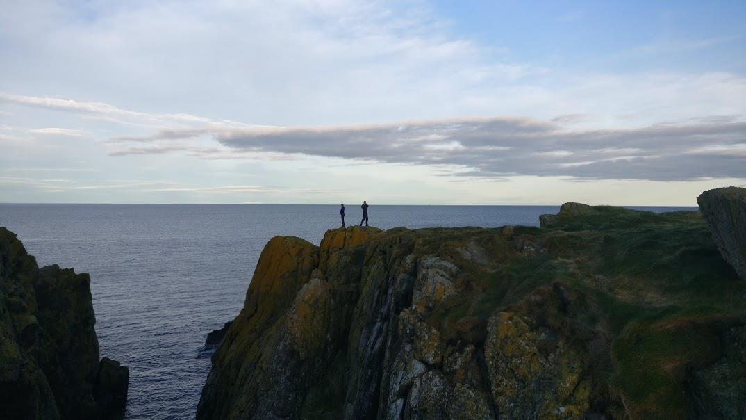 Looking down at the yellow, lichenous rocks.